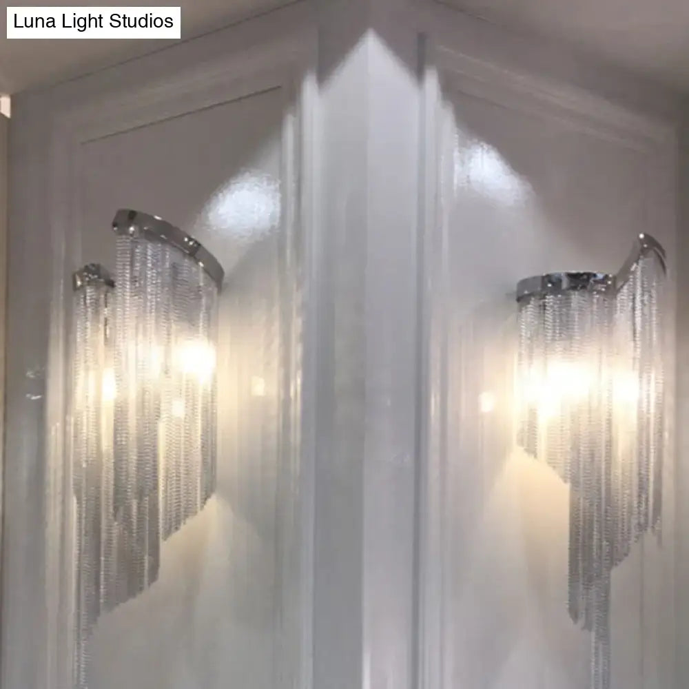 Modern abstract silver wall light featuring silver-toned wall sconces with cascading crystal chains and tassel aluminum shade