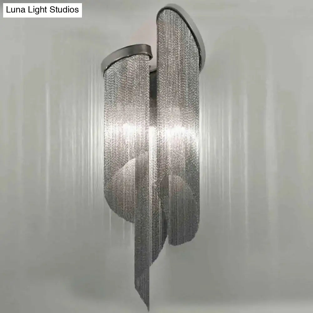 Silver chain-link wall light with modern flowing design and tassel aluminum shade for living room decor