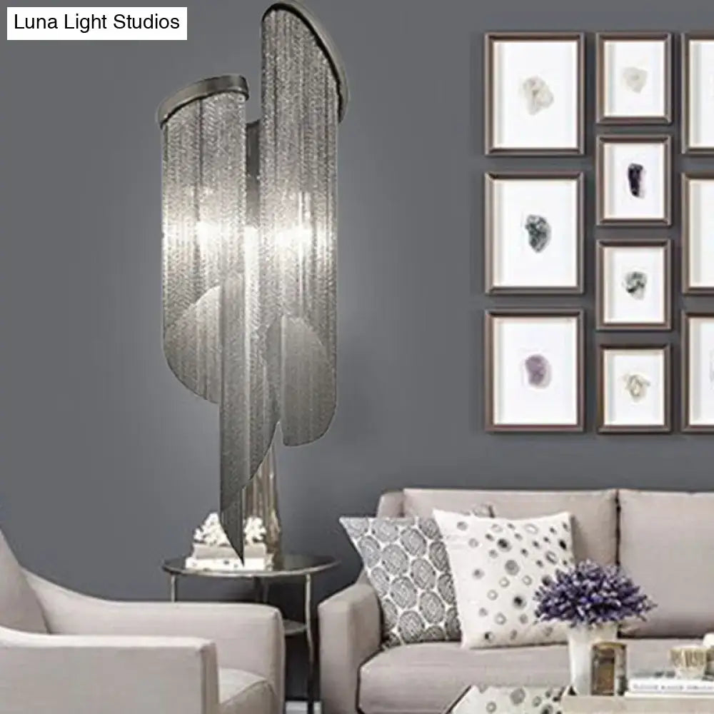 Modern abstract silver wall light with tassel aluminum shade featuring a silver metallic chandelier with crystal strands