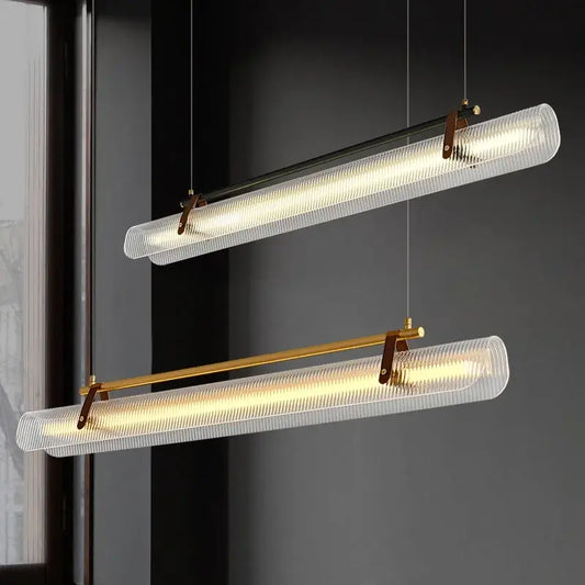 Two modern pendant lights with textured glass shades and brass accents provide an elevated light source