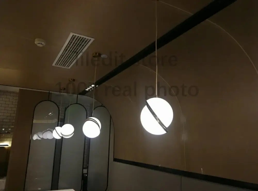Modern acrylic ball pendant lamp featuring a white spherical pendant light with a black circular accent band for living room