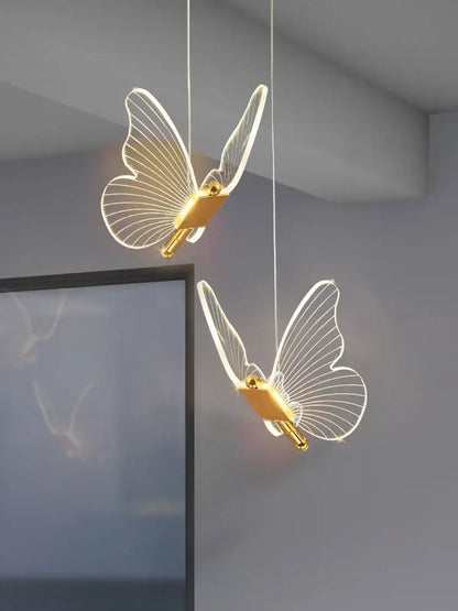 Two elegant translucent acrylic butterfly led chandelier pendant lights with gold bodies for bedroom lighting decorbites butterfly led