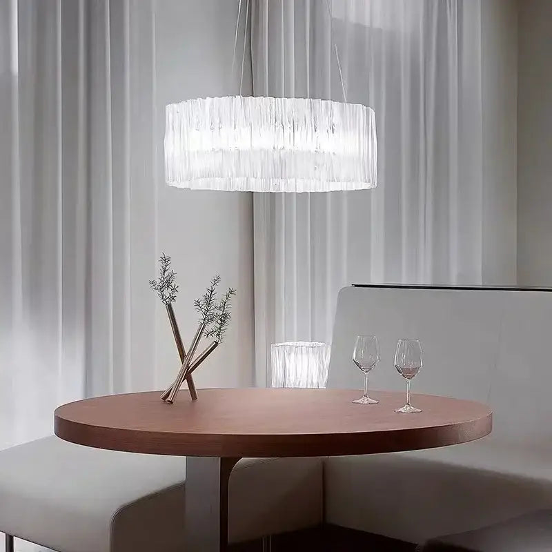 Modern acrylic ceiling chandelier with a gold ring and translucent white ridged glass shade for dining room lighting