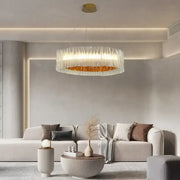 Modern acrylic ceiling chandelier with a gold ring and translucent glass panels for dining room lighting