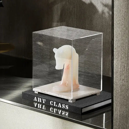 Modern acrylic display case with travertine base featuring a translucent white marble horse sculpture inside acrylic display