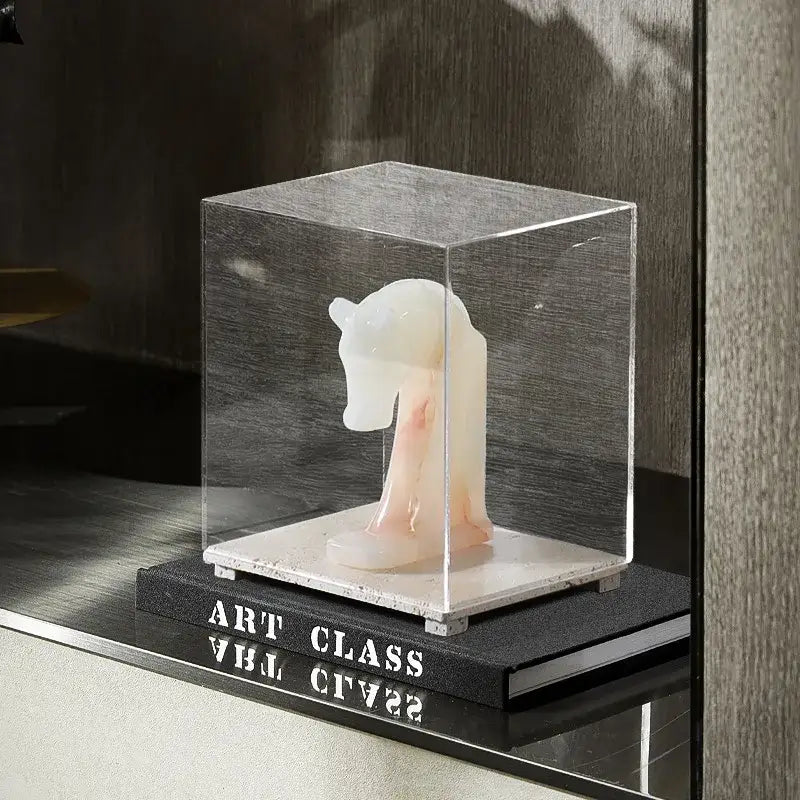 Modern acrylic display case with travertine base featuring a translucent white marble horse sculpture inside acrylic display