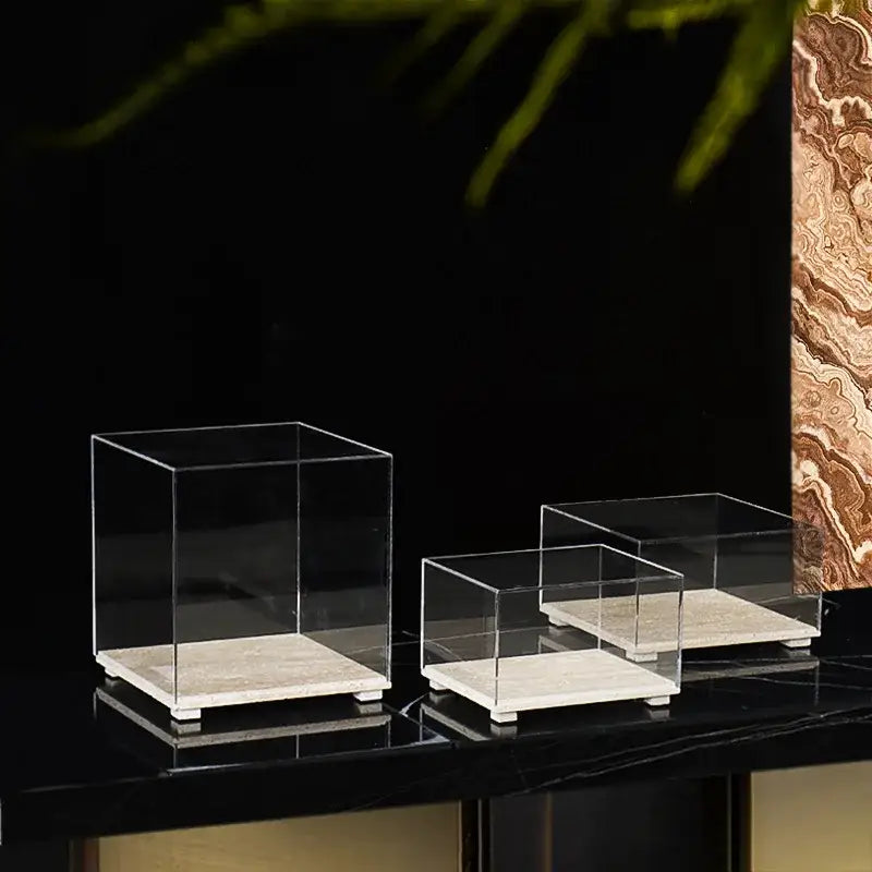 Modern acrylic display case with clear acrylic cube stands and light travertine marble base for dining room use
