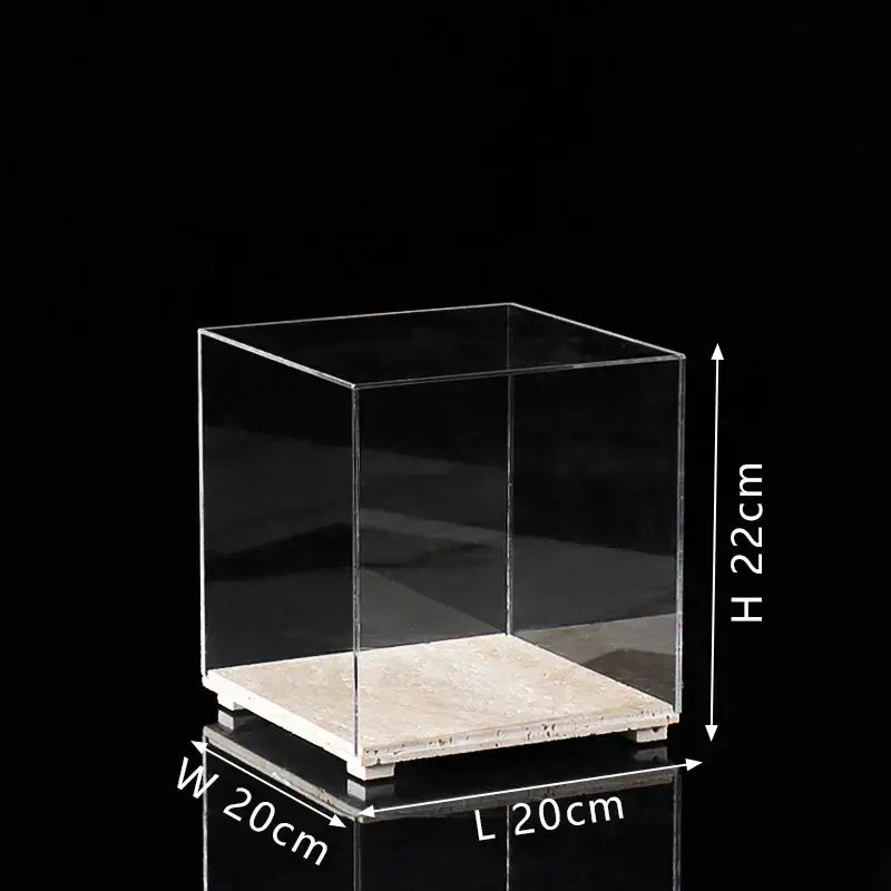Modern acrylic display case with clear cube design and light beige travertine base for dining room use