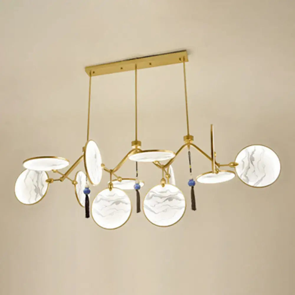 Gold-toned decorbites™ modern acrylic led island lamp with circular marble-patterned glass shades and blue tassels