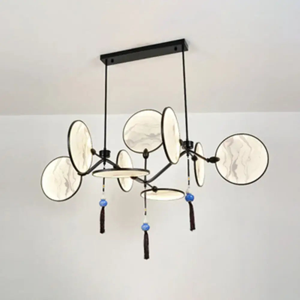 Modern acrylic led DecorBites island lamp with black metal frame, circular marble-patterned shades, and blue tassels