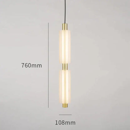 Modern acrylic minimalist pendant lights featuring two frosted glass cylinders with brass accents on black cords