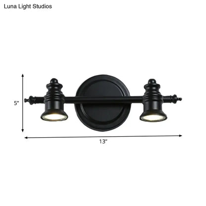 Black matte wall light fixture with two adjustable spotlights and circular mounting plate for bathroom vanity use