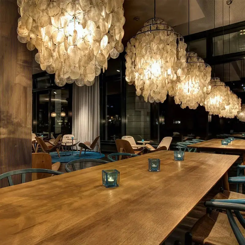 Modern aeolian bells shell chandelier features translucent shell glass discs in cascading clusters for elegant living room decorbites lighting
