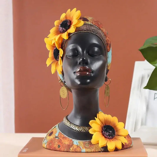 A glossy black resin african beauty figurine adorned with yellow sunflowers and a patterned headwrap for decorbites african decor