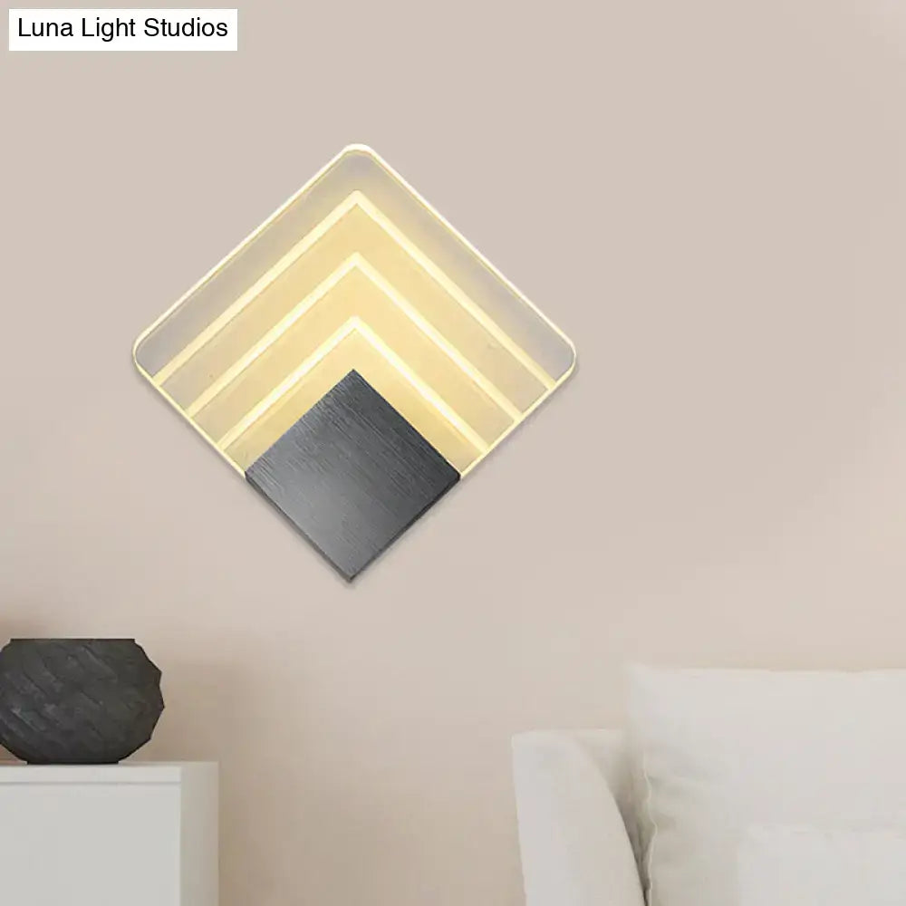 Modern aged silver and black square led wall sconce with layered diamond-shaped geometric lighting and matte black panel
