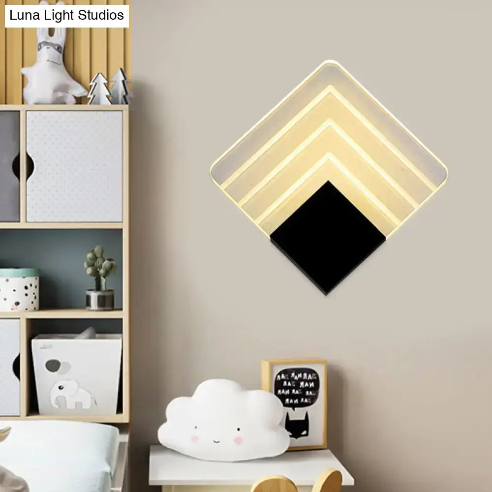 Modern aged silver and black square led wall sconce with diamond-shaped layered design and warm white led lighting