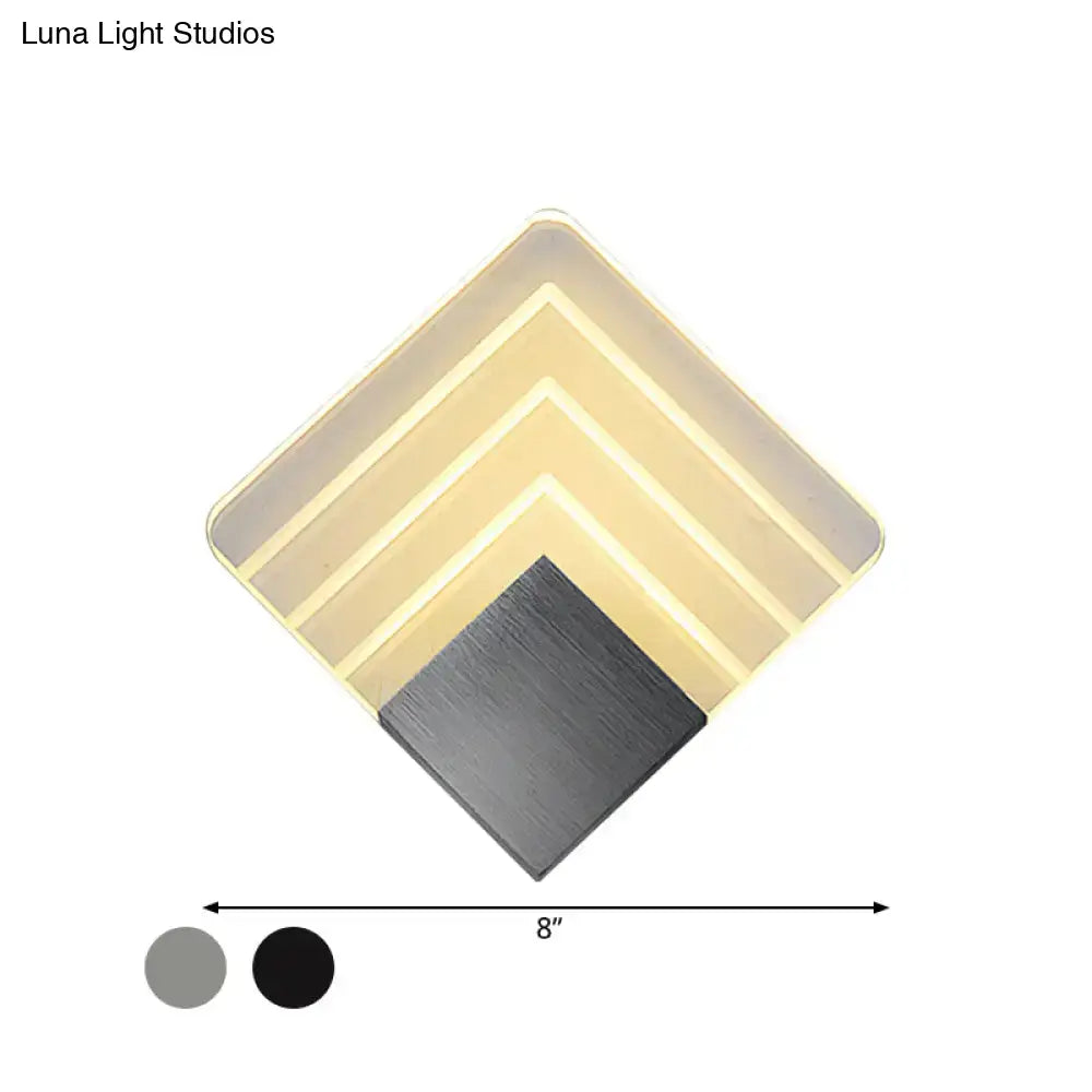 Modern aged silver and black diamond-shaped led wall sconce with layered translucent panels and brushed metal base
