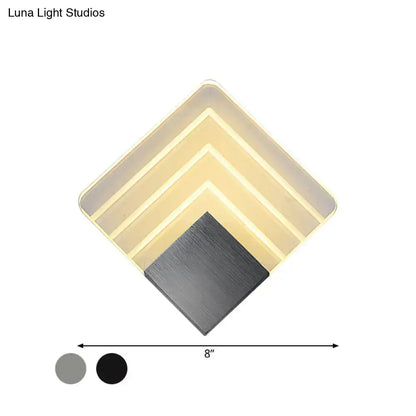 Modern aged silver and black diamond-shaped led wall sconce with layered translucent panels and brushed metal base