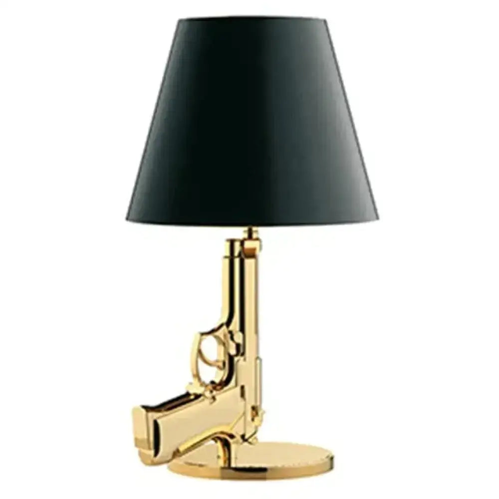 Modern ak47 gun lounge floor lamp with gold-colored pistol base and black conical shade in silvery gold lustre