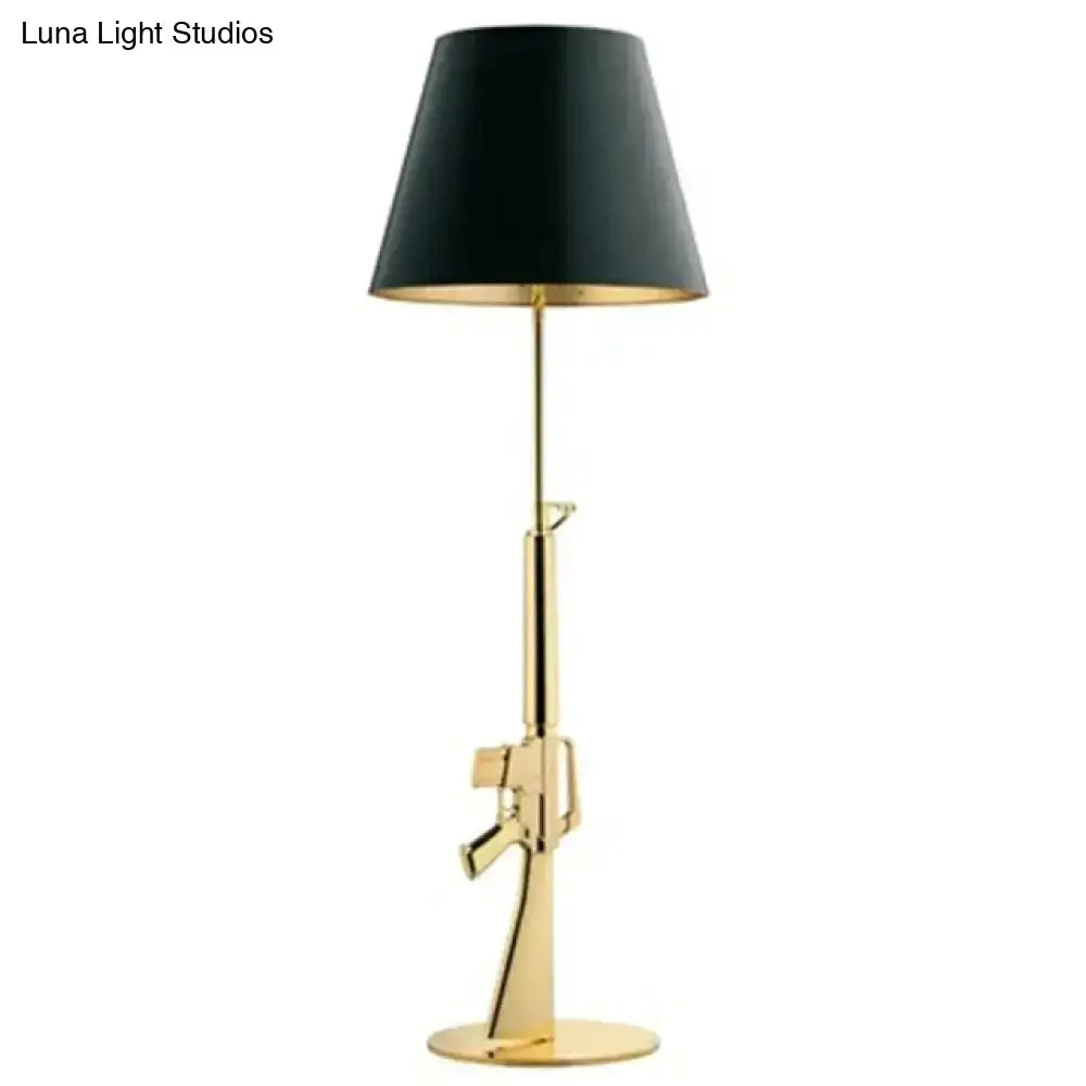 Modern ak47 gun lounge floor lamp in silvery gold lustre with black conical shade and gold interior lining for bedroom lighting