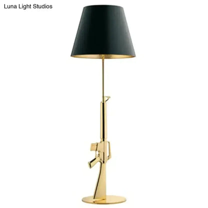 Modern ak47 gun lounge floor lamp in silvery gold lustre with black conical shade and gold interior trim for bedrooms