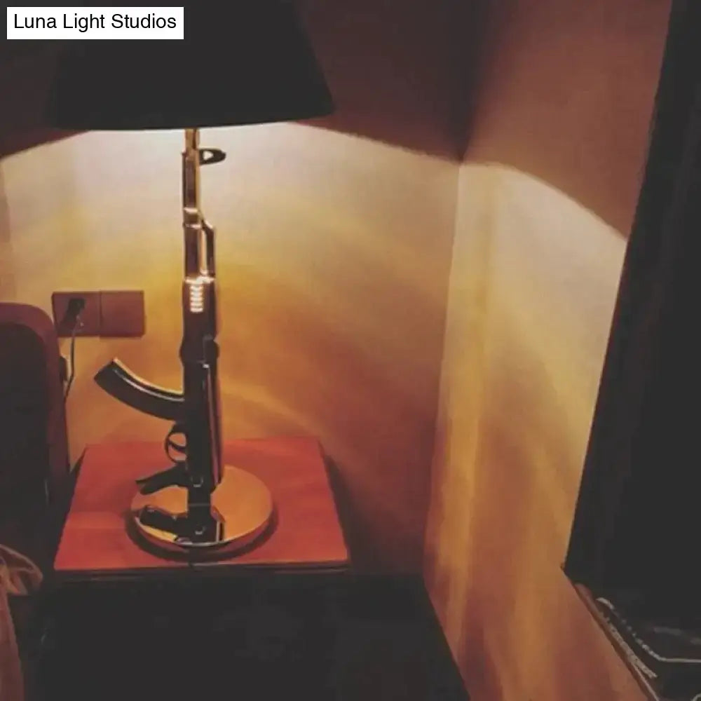 Modern ak47 gun lounge floor lamp with black rifle-shaped base and silvery gold lustre metallic accents for bedroom light