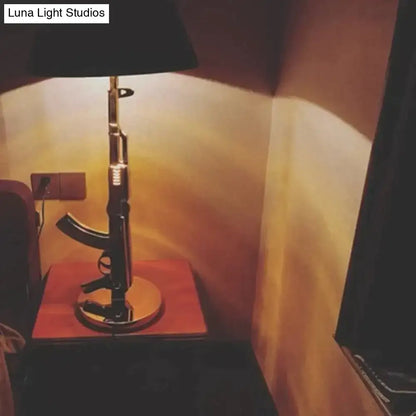 Modern ak47 gun lounge floor lamp with black rifle-shaped base and silvery gold lustre metallic accents for bedroom light