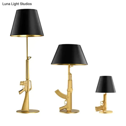 Set of three modern ak47 gun lounge floor lamps with silvery gold lustre finish and black conical shades by Luna Light Studios