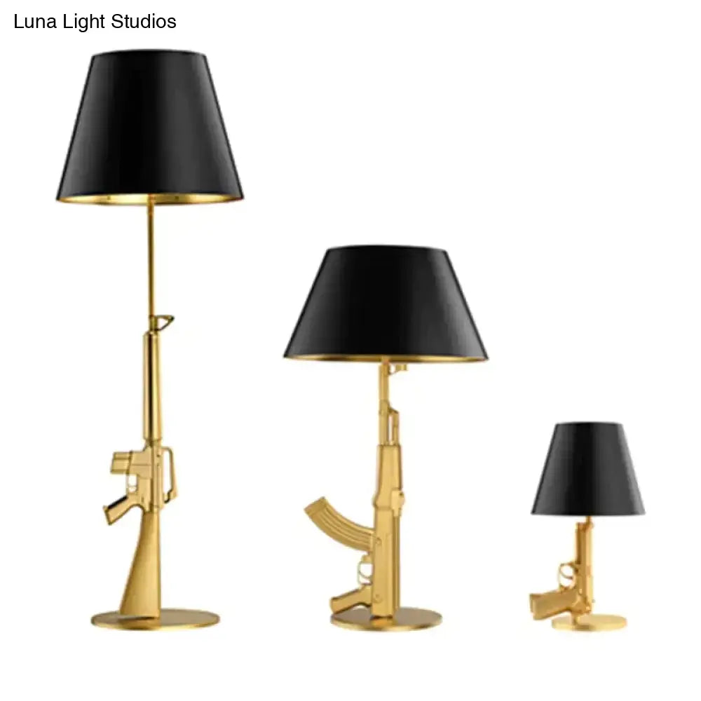 Set of three modern ak47 gun lounge table lamps in gold finish with black conical shades for stylish bedroom lighting