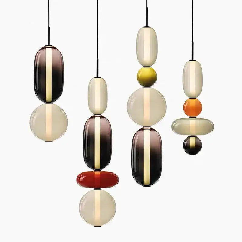 Modern pendant lights featuring stacked colorful glass balls in amber cream and deep brown for dining room use