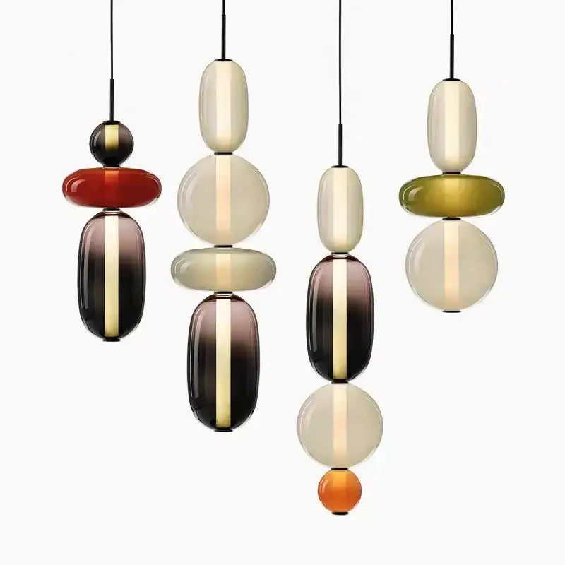 Modern pendant lights with colorful glass ball orbs in amber cream and olive green for dining room lighting