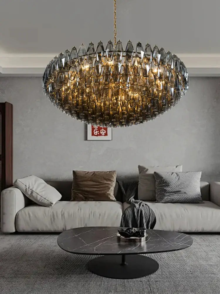 A modern amber and gray glass chandelier with gold-toned chain and faceted crystals for luxury dining room decorbites colorful gray style
