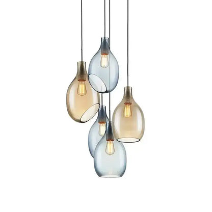Modern amber and blue glass pendant lights with five teardrop-shaped shades and warm filament bulbs for kitchen use