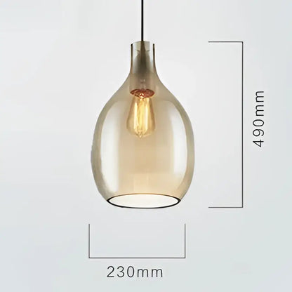 A sleek amber glass pendant light with visible filament bulb, part of modern kitchen glass pendant lights collection