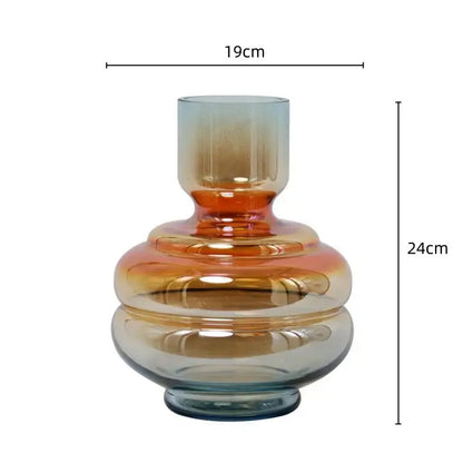 A sleek modern decorbites gradient glass vase with amber and blue hues featuring layered rounded contours for living room decor