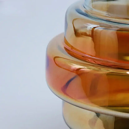 A modern translucent amber glass tiered candle holder with smooth edges and glossy finish by decorbites gradient glass