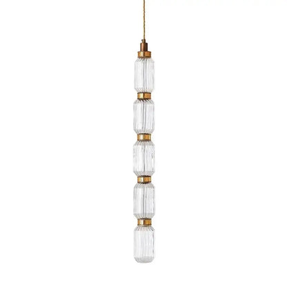Clear faceted glass ballet pendant lamp with brass accents and gold cord for modern dining room lighting