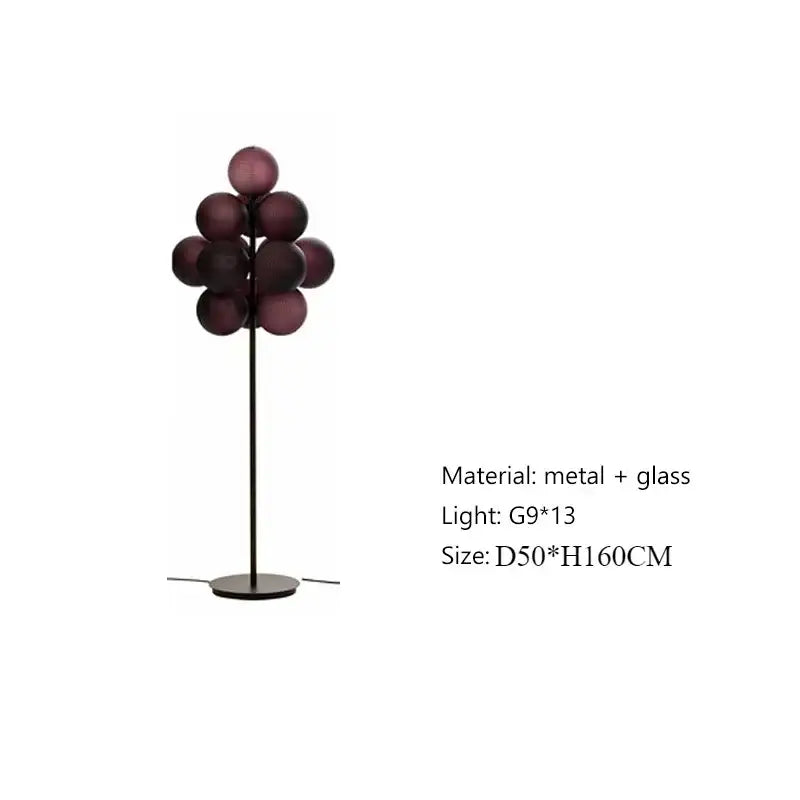 Modern floor lamp with slender black metal stand and deep purple glass spheres in a lamp set for living room use