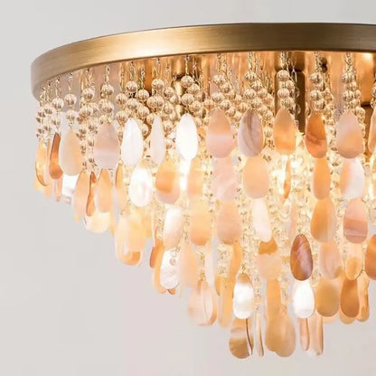 A luxurious gold-toned modern amber and clear decorbites crystal led ceiling lamp with mother-of-pearl beads for living room decor