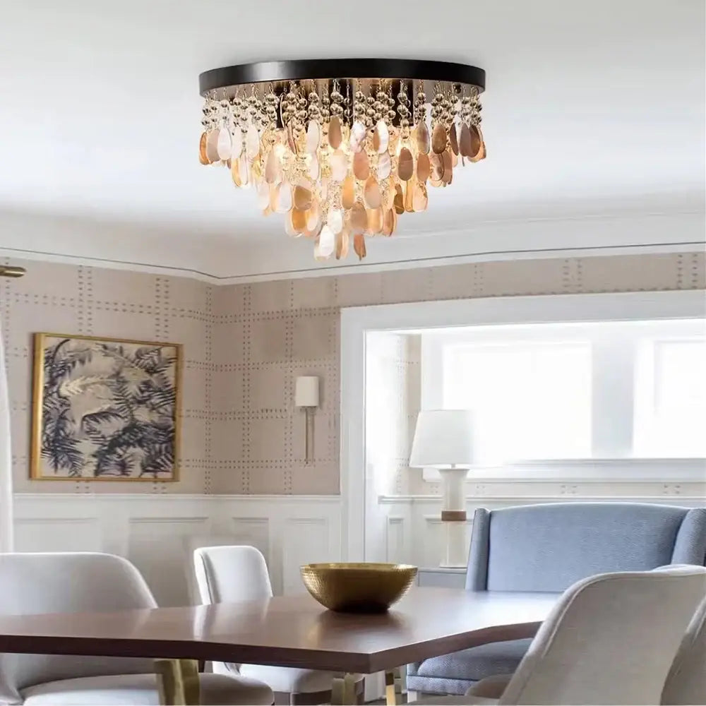 A modern amber and clear decorbites crystal led ceiling lamp with black frame and golden rose-gold leaf crystals