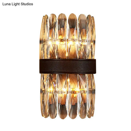 Modern amber and clear crystal wall sconce with faceted prisms and dark brown leather band direct wired electric power source