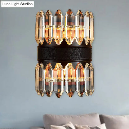 Modern amber and clear crystal wall sconce with black leather band and warm lighting for direct wired electric use