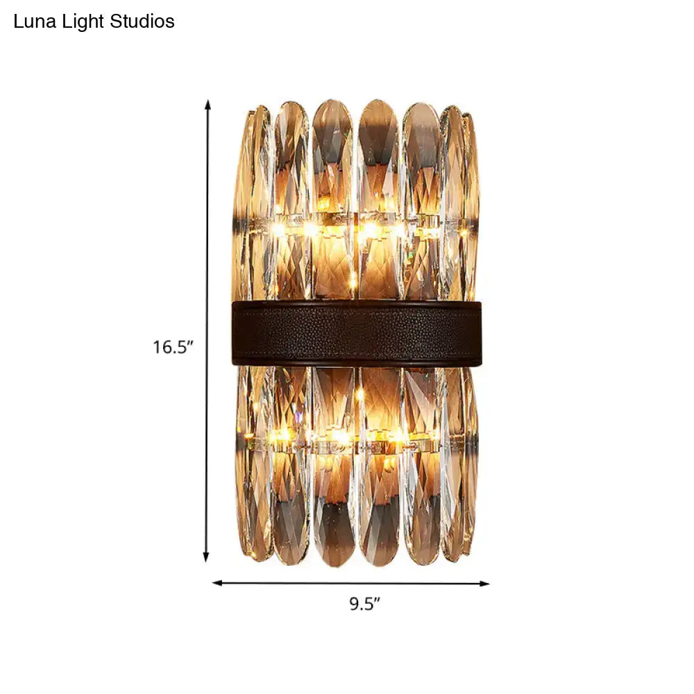 Modern amber and clear crystal wall sconce with faceted amber crystals and dark leather strap for direct wired electric use