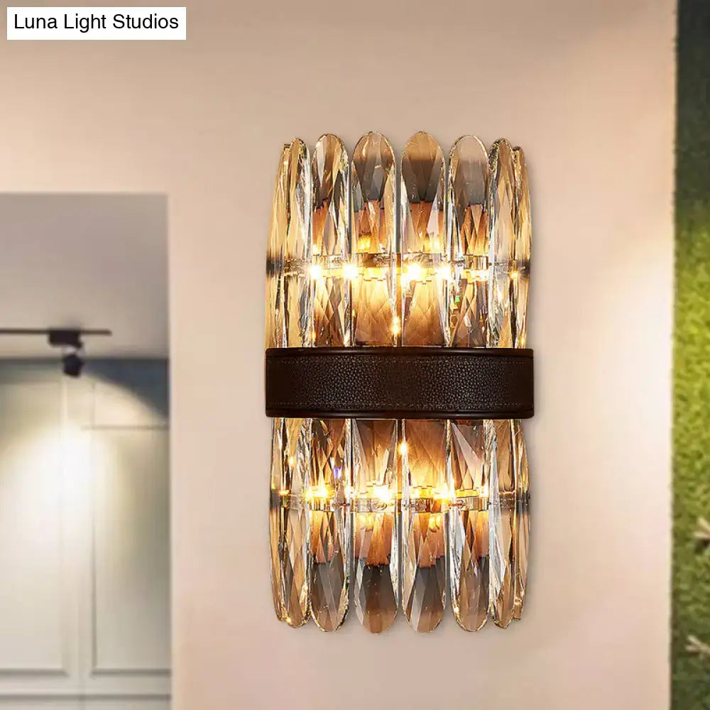 Modern amber and clear crystal wall sconce with faceted glass and dark brown leather strap for direct wired electric power source