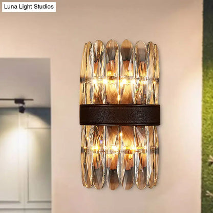 Modern amber and clear crystal wall sconce with faceted glass and dark brown leather strap for direct wired electric power source