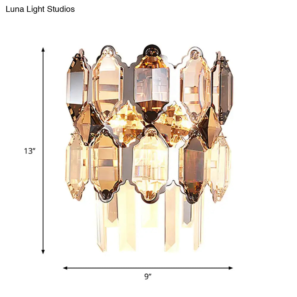 Modern amber and clear crystal wall sconce with faceted glass and brass frame ideal for staircase lighting