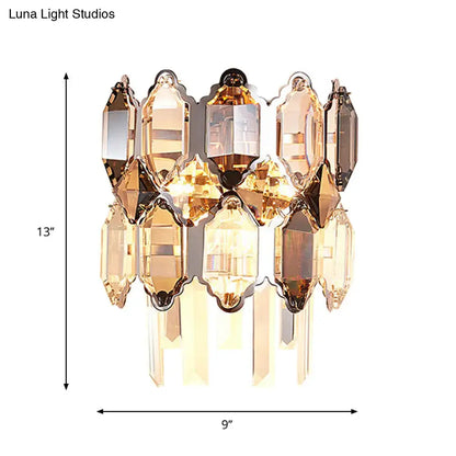 Modern amber and clear crystal wall sconce with faceted glass and brass frame ideal for staircase lighting