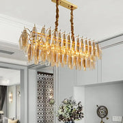 Modern amber crystal oval island light fixture featuring a golden chandelier with amber glass crystals for dining room