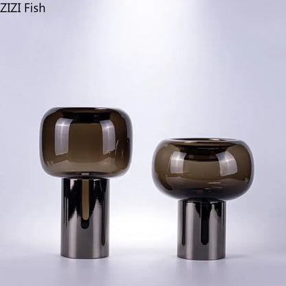 Two sleek modern decorbites dark glass vases with amber hue and silver bases for office desk decor