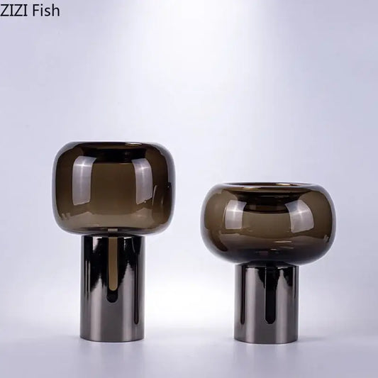 Two sleek modern decorbites dark glass vases with amber hue and silver bases for office desk decor